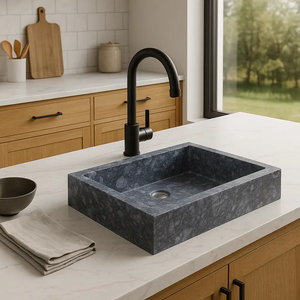 Gray marble vessel sink with black high-arc faucet on white marble countertop.