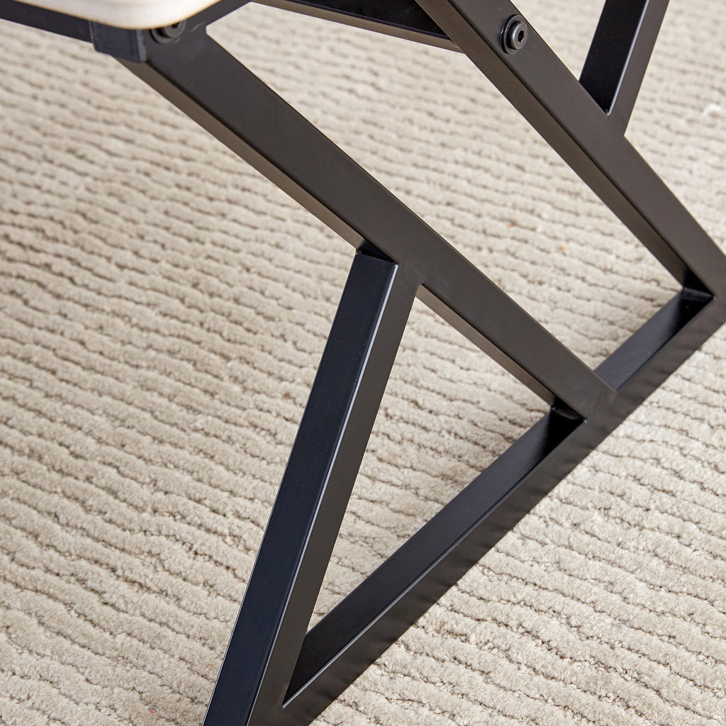 A coffee table made of rock slab material, with a smooth and natural surface that complements the modern design of the black metal legs, making it suitable for living rooms of all sizes.47*23.6