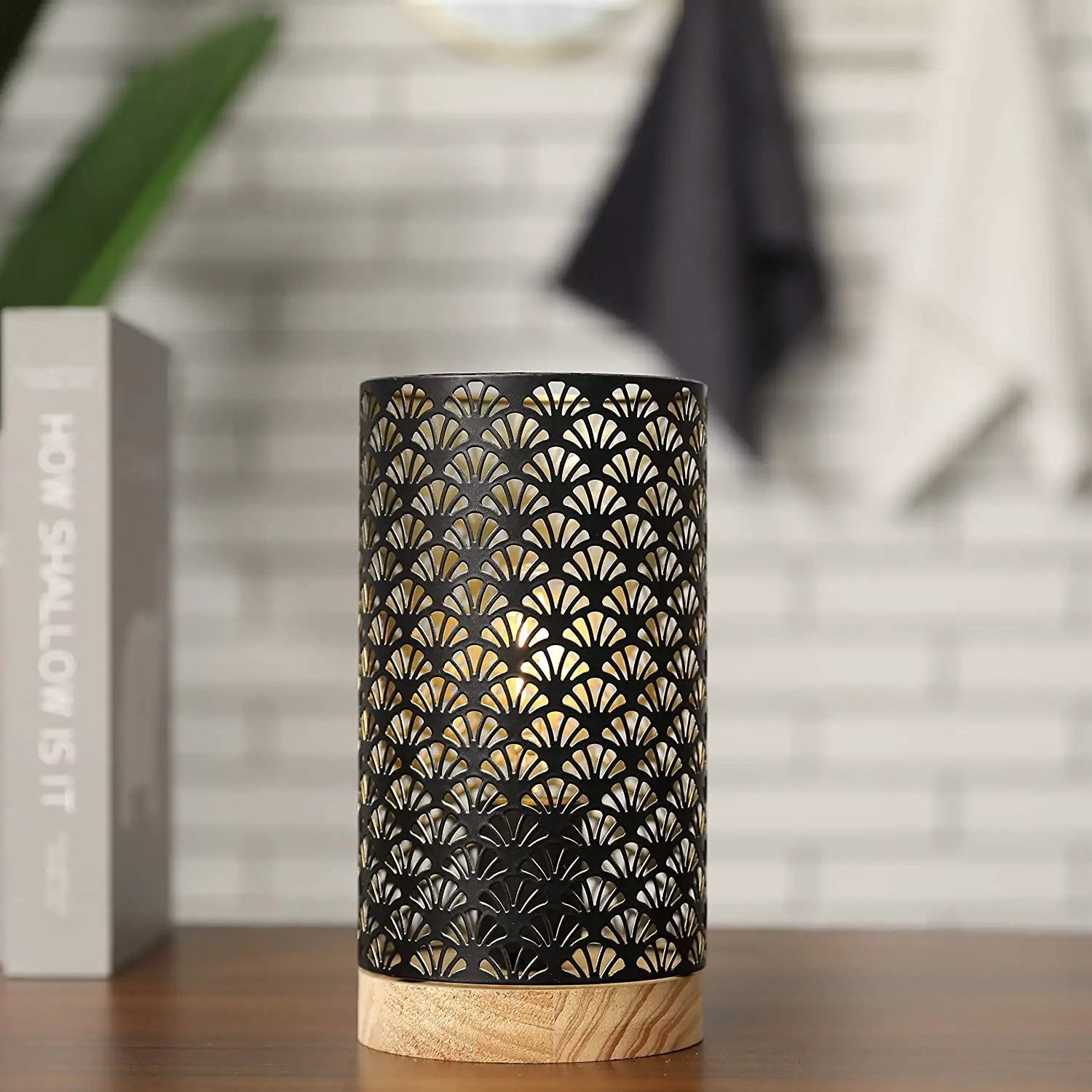 7.5-inch cordless metal lamp with a black perforated lattice shade on a wood base, warm glow.