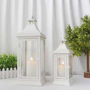 Decorative outdoor candle lanterns by JHY DESIGN, white metal with glass panels, set of 2 in 19.5" and 13" heights.