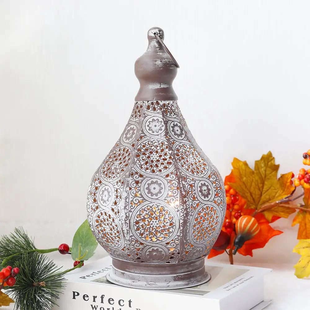 11.5in tall battery-powered table lamp; gray distressed metal with ornate perforated lattice pattern