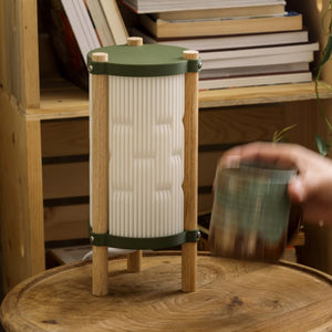 Toro Table Lamp by Terra Labs; green metal caps with wooden posts and a white ribbed shade