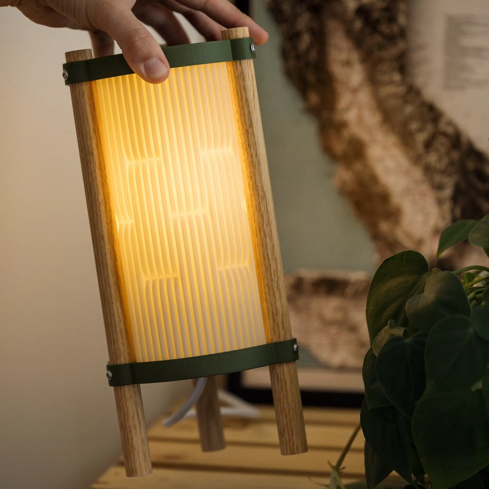 Toro table lamp by Terra Labs; wood body with ribbed shade and green metal band.