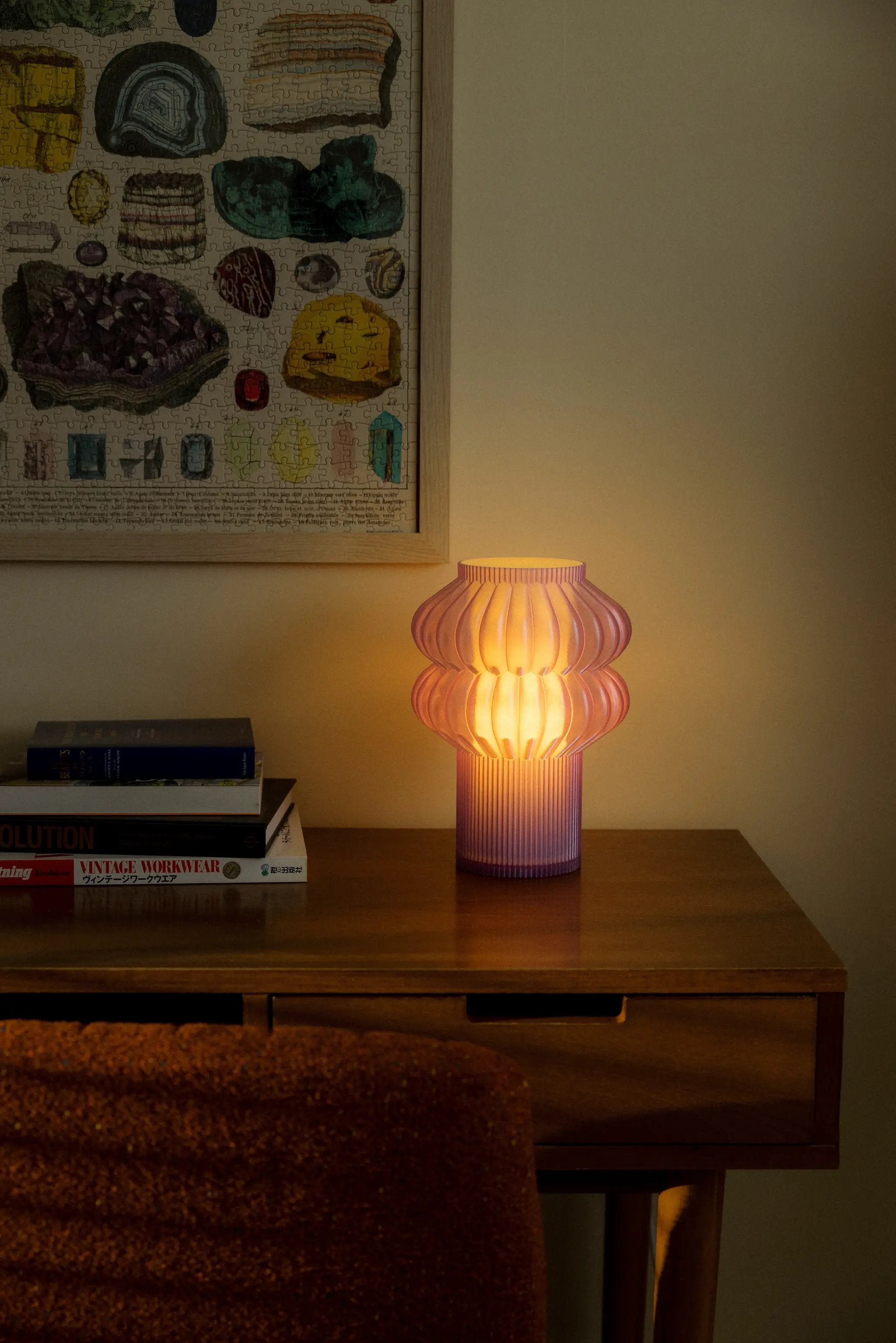 Oppi table lamp pink ribbed glass with warm glow on wooden table