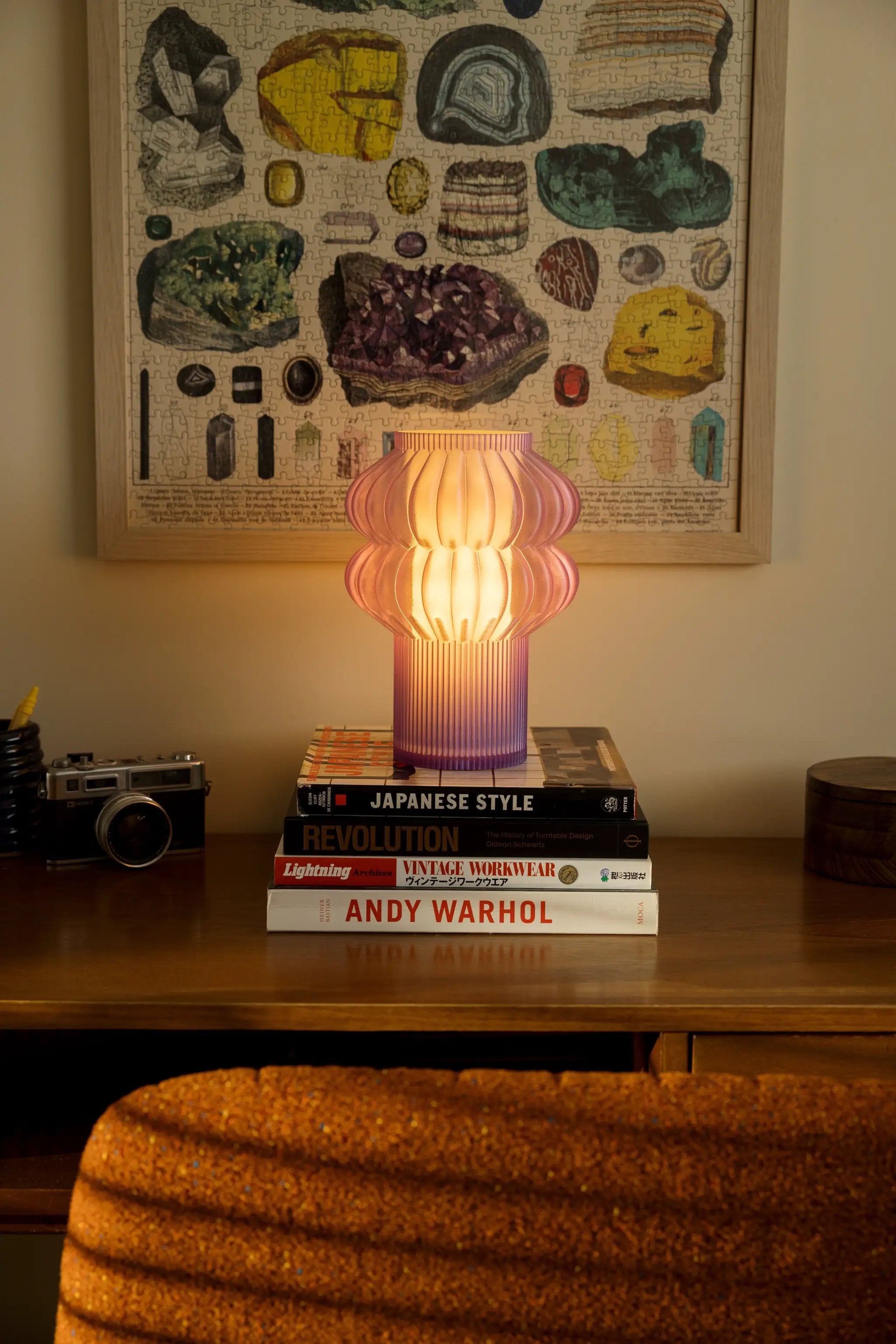 Oppi table lamp, pink ribbed glass by Terra Labs, warm glow on desk