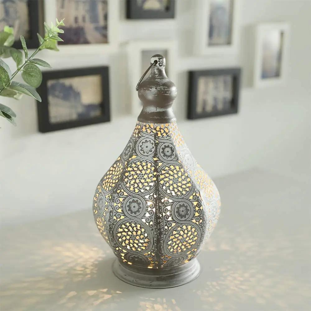 11.5in battery-powered table lamp by JHY DESIGN; decorative metal lantern with gray and gold pattern.