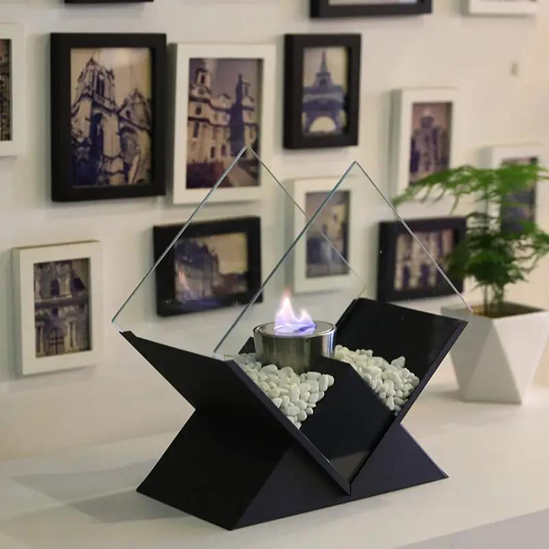 JHY DESIGN tabletop fireplace, 14.5 in tall, black base with white stones and glass panels around an ethanol burner.