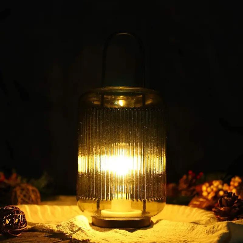 11.5''H battery-powered table lamp, amber-green ribbed glass lantern with handle.