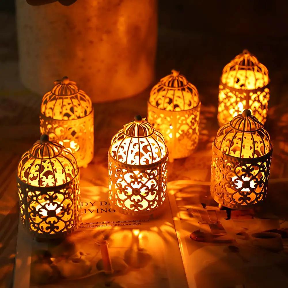 Six small metal candle lanterns with ornate filigree patterns, glowing warm amber light.