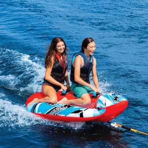 Towable tube WOW Watersports Sub-Zilla 2-Person with two riders wearing life vests on a red and blue inflatable