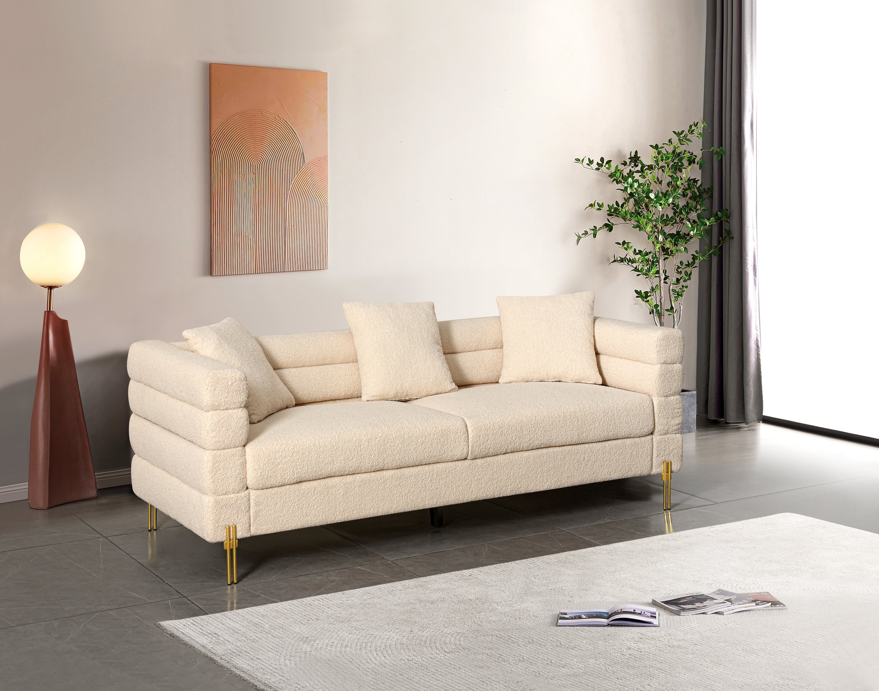 Luxurious and comfortable upholstered sofa with golden legs and pillows for living room and reception area