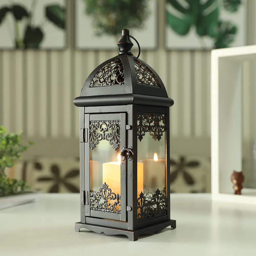 15-inch high decorative candle lantern in black metal with ornate lattice panels and glass, candle inside