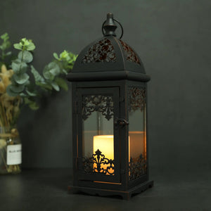 15-inch High Decorative Candle Lantern in black by JHY DESIGN with ornate metal lattice and a glowing candle