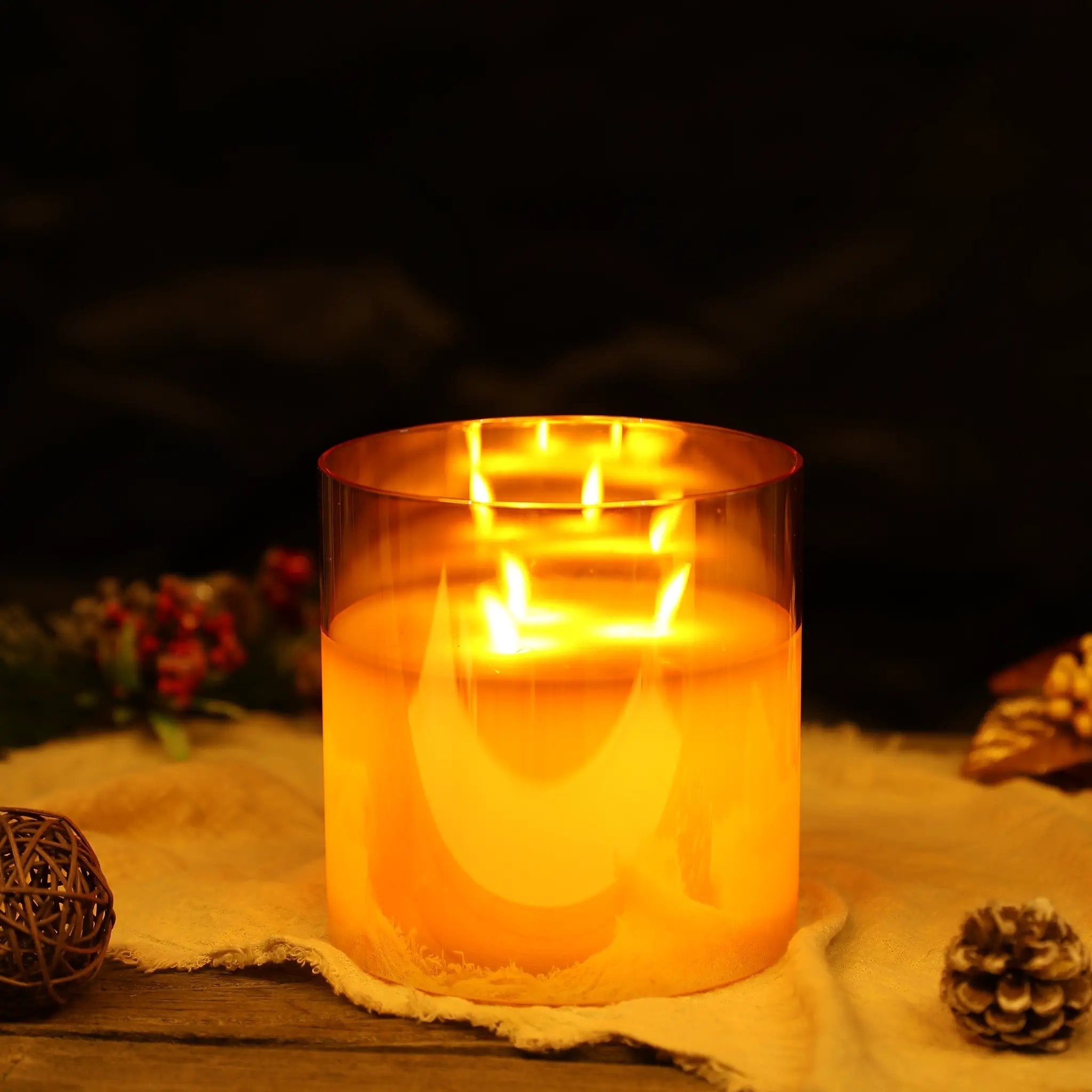 6-inch gold-tinted glass flameless candle with 3 wicks; battery-operated, warm amber glow.
