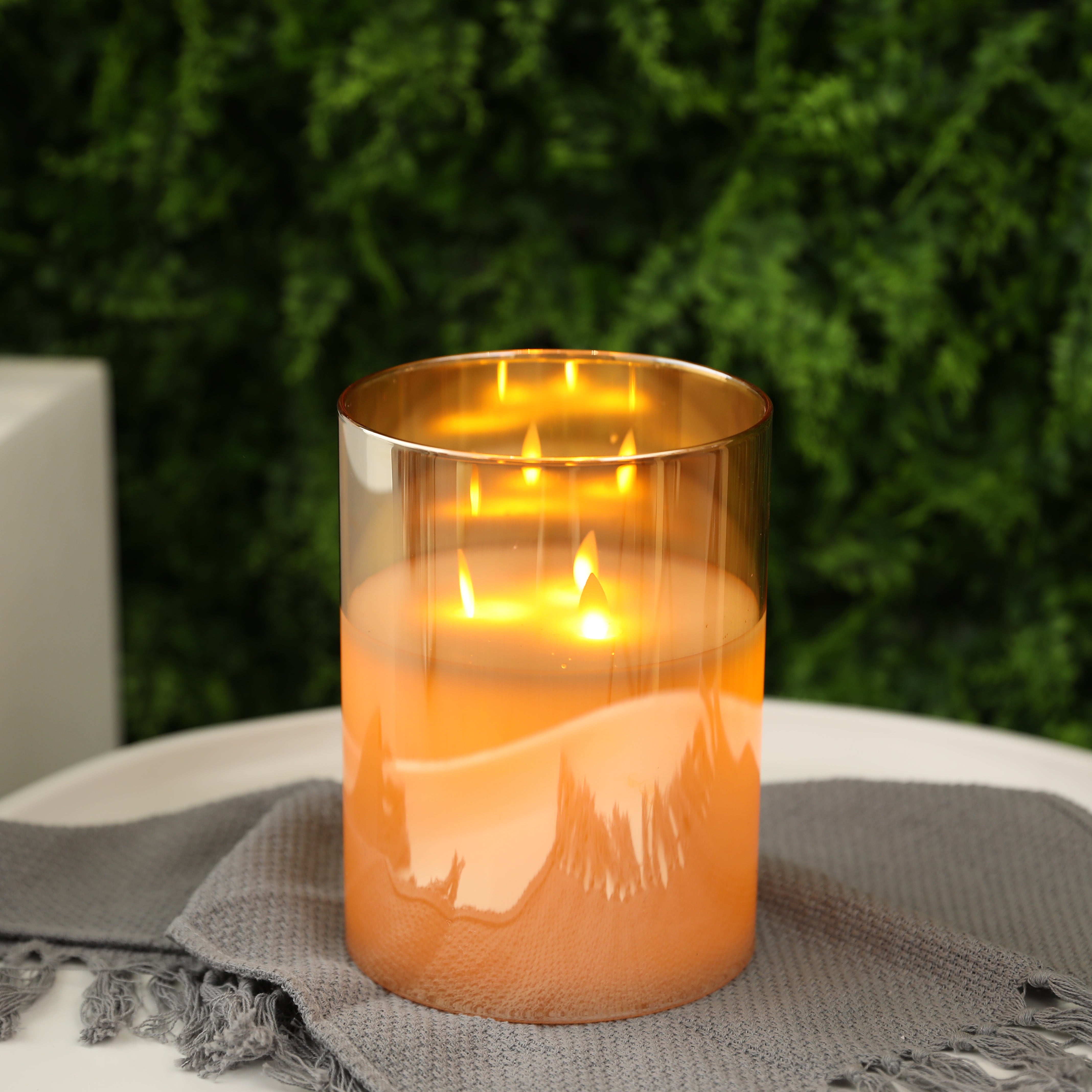 8-inch high glass 3-wick flameless candle in amber-yellow gradient with warm LED flames