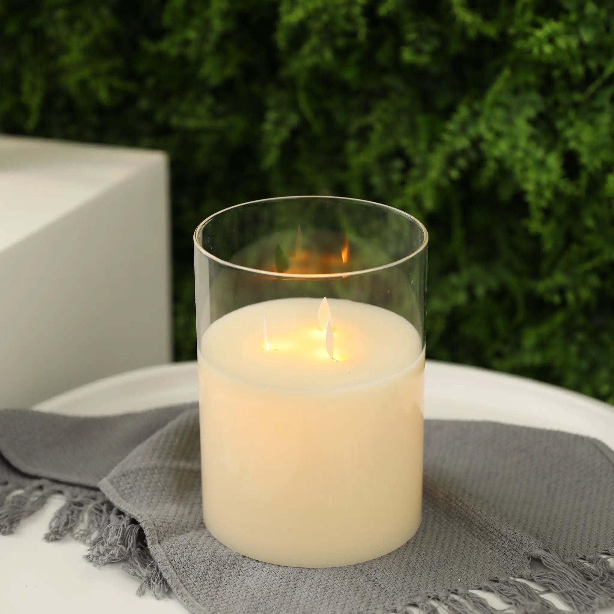 8-inch high 3-wick glass battery-operated flameless candle, white.