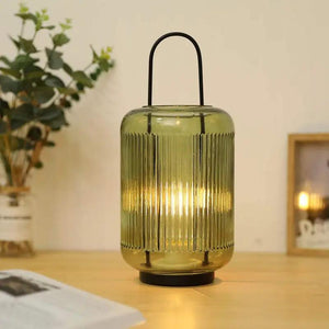 11.5-inch high battery-powered table lamp, amber-green ribbed glass with a black arched handle by JHY DESIGN