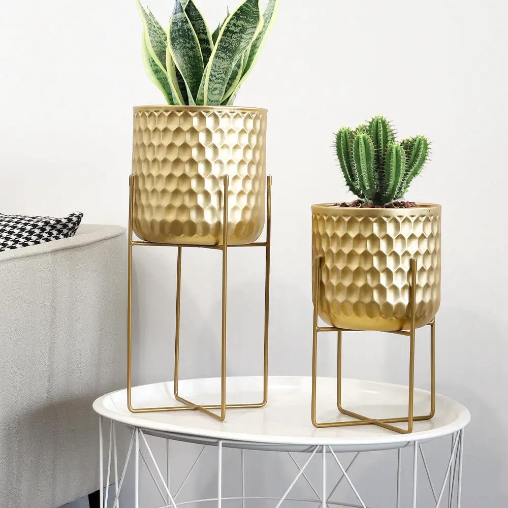 Two gold hammered planters on matching stands, 17- and 12-inch tall