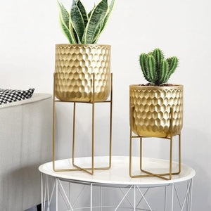Two gold hammered planters on matching stands, 17- and 12-inch tall