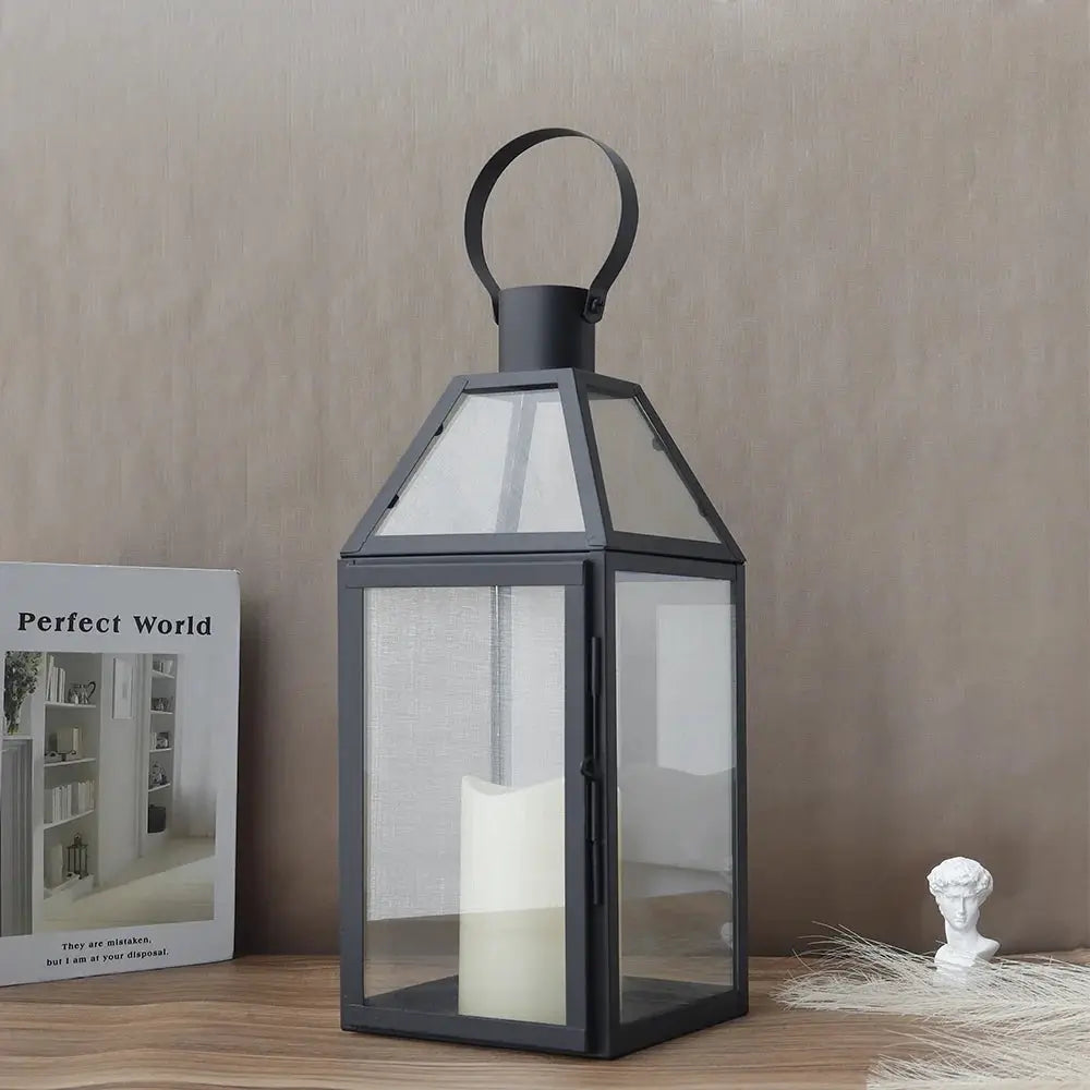 16-inch stainless steel black decorative candle lantern with glass panels and a loop handle.