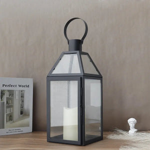16-inch stainless steel black decorative candle lantern with glass panels and a loop handle.