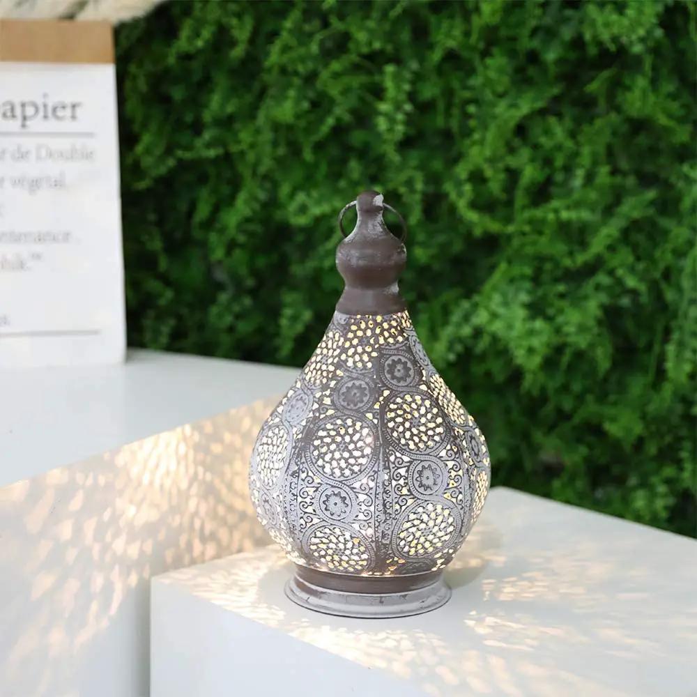 11.5'' Tall Battery Powered Table Lamp with ornate grey metal lattice, casts warm light.