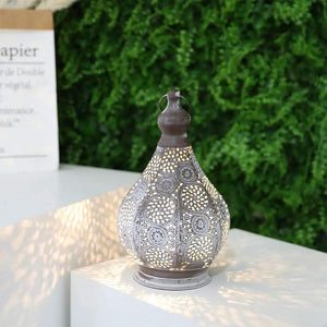 11.5'' Tall Battery Powered Table Lamp with ornate grey metal lattice, casts warm light.