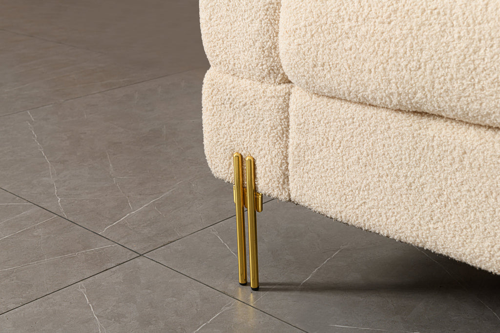 Luxurious and comfortable upholstered sofa with golden legs and pillows for living room and reception area