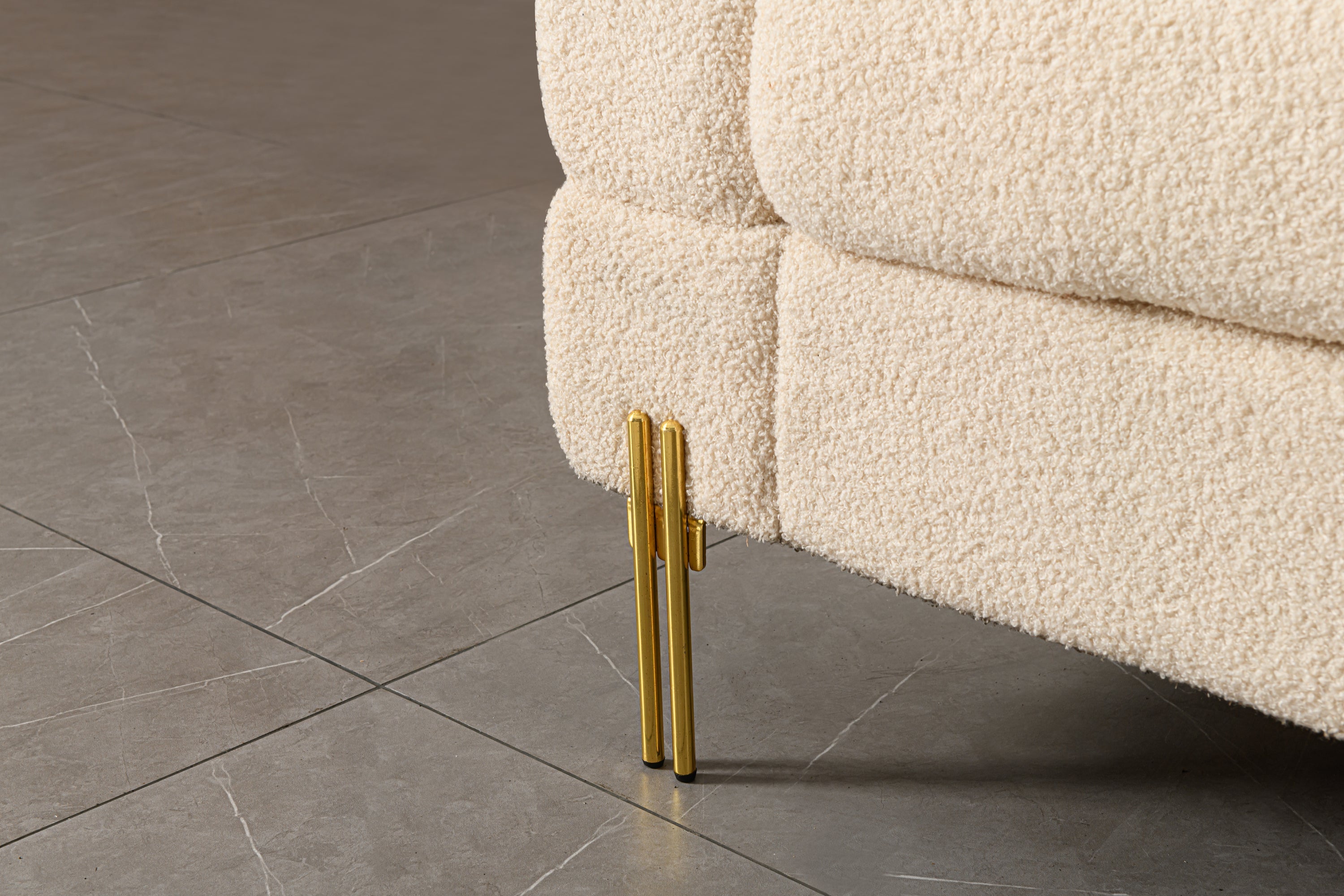 Luxurious and comfortable upholstered sofa with golden legs and pillows for living room and reception area