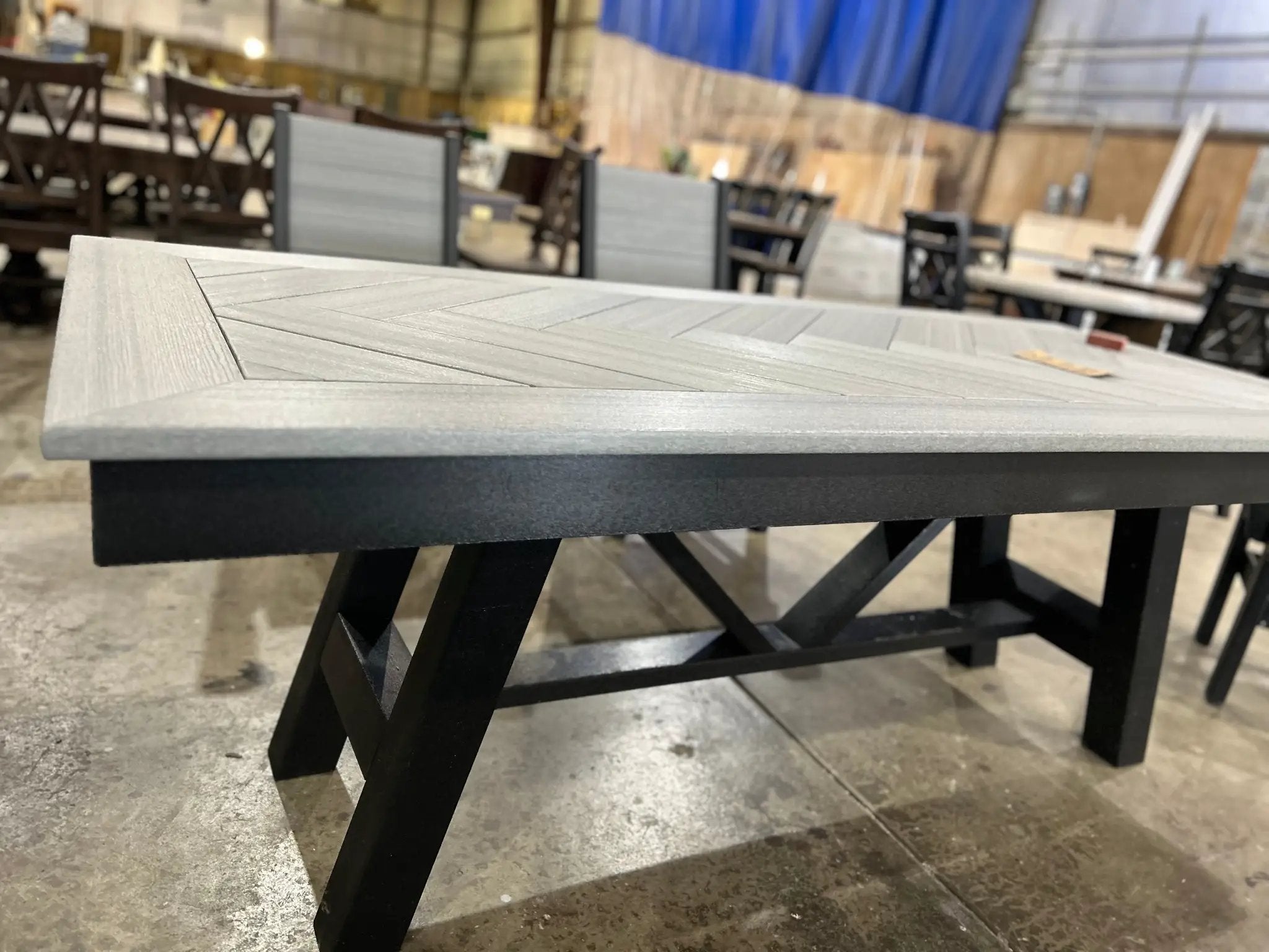Harmony Outdoor Table by Wooden Whale Workshop; gray wood-look top with black metal legs.
