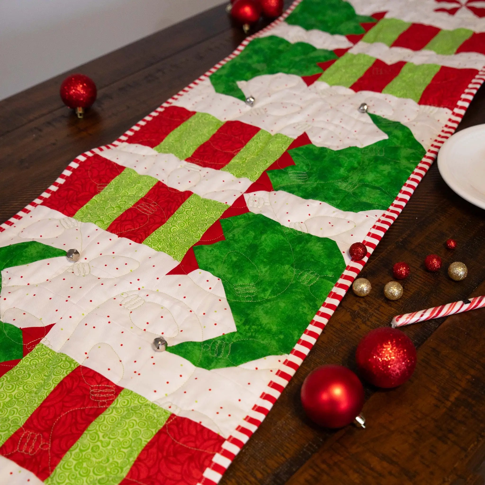 Elf Feet Christmas Table Runner quilt kit, precut; red and green patchwork with candy-cane binding.
