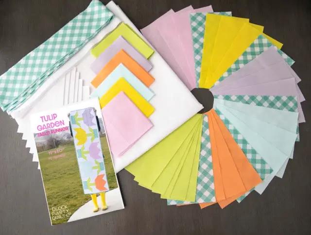 Quilt Kit: Spring Quilted Table Runner Bundle by Block Party Quilt Co with pastel fabric squares.