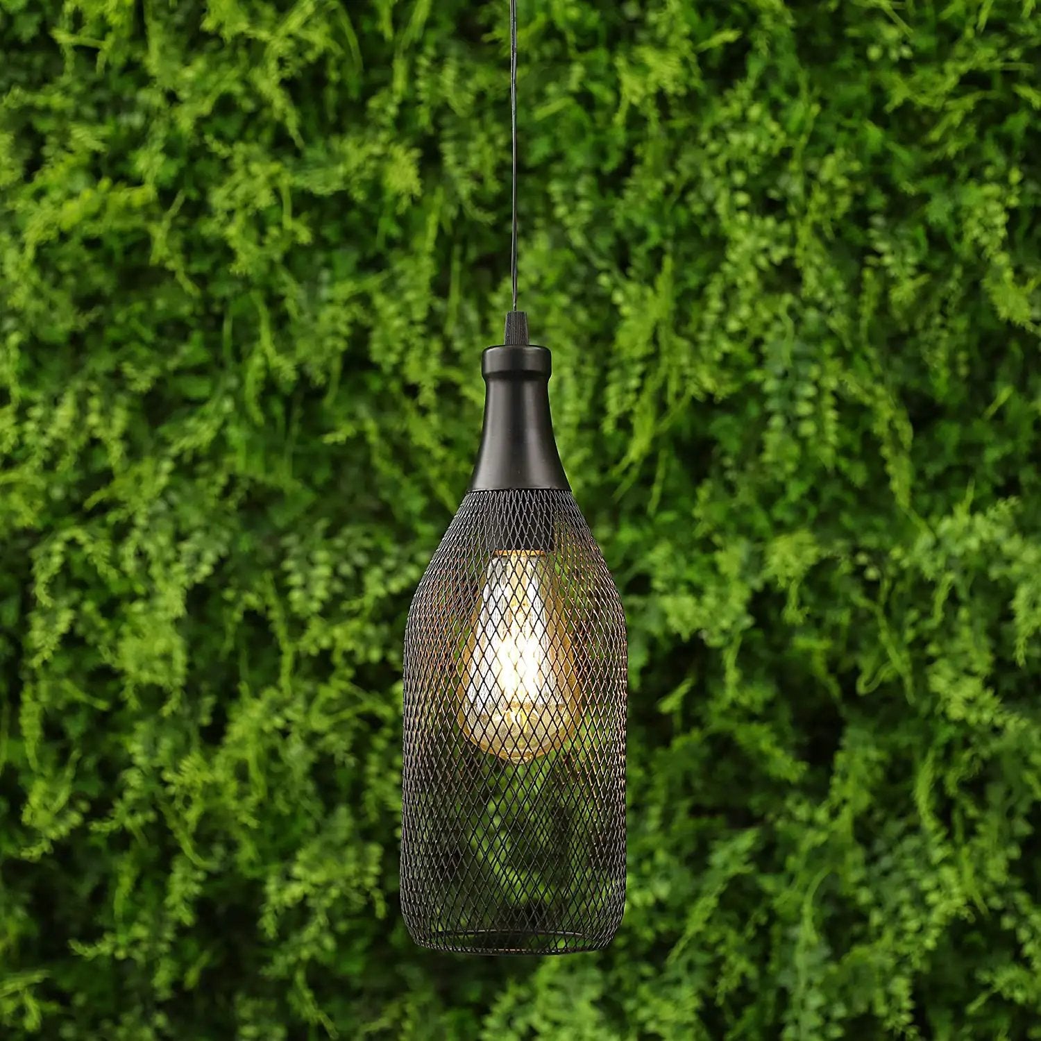 Battery powered hanging pendant lamp with black metal mesh shade and warm Edison bulb.