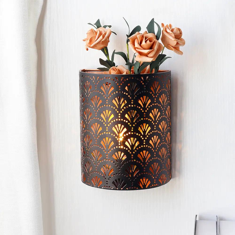 8'' H metal rustic wall-mount lamp with perforated fan-pattern cylinder and warm glow, battery-operated