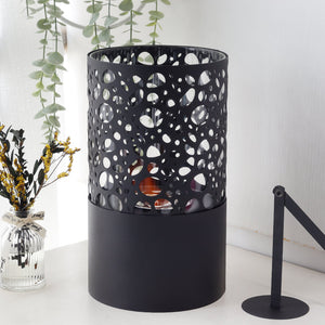 Tabletop fireplace in black perforated metal with circular cutouts, gel and ethanol fuel for home and garden.
