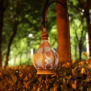 JHY DESIGN 11.5'' tall battery-powered table lamp, gold-toned perforated metal lantern with warm glow.