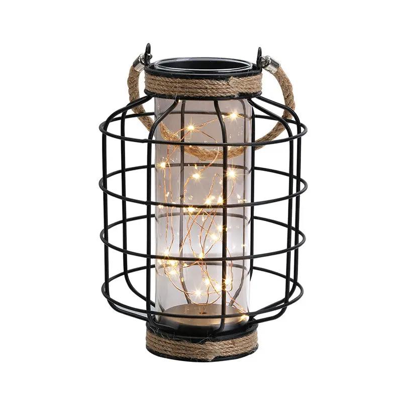 9.4-inch battery-powered table lamp with black metal cage and rope accents, string lights inside.