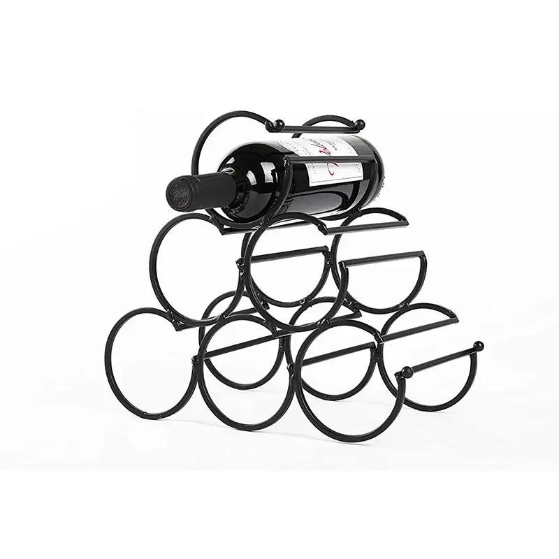 Iron tabletop wine rack in black metal with circular bottle holders and a bottle resting on top.