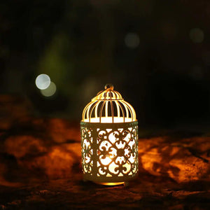 JHY DESIGN petite metal candle lantern with intricate cutwork and domed top, warm glow.