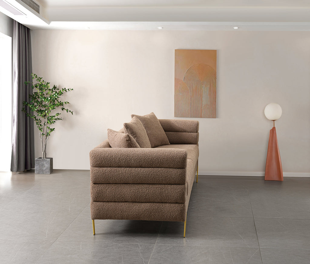 Luxurious and comfortable upholstered sofa with golden legs and pillows for living room and reception area