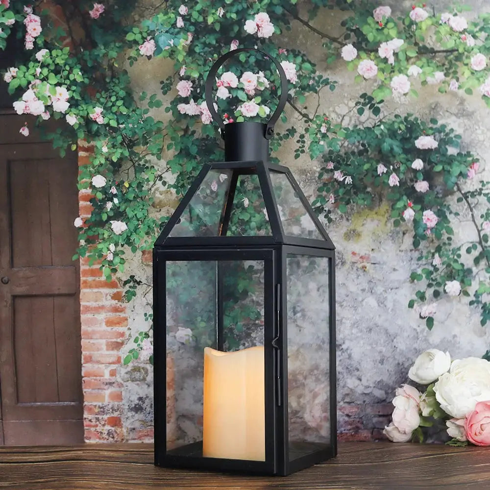 16-inch black stainless steel decorative candle lantern by JHY DESIGN with glass panels and a lit candle