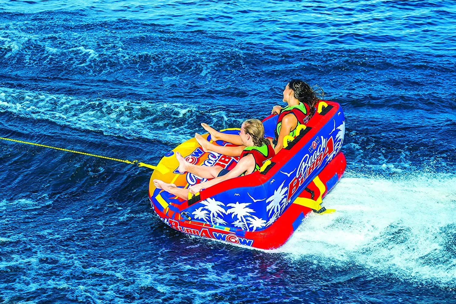 WOW Watersports Beach Bubba 2P towable raft for two, blue and red with palm tree graphics.