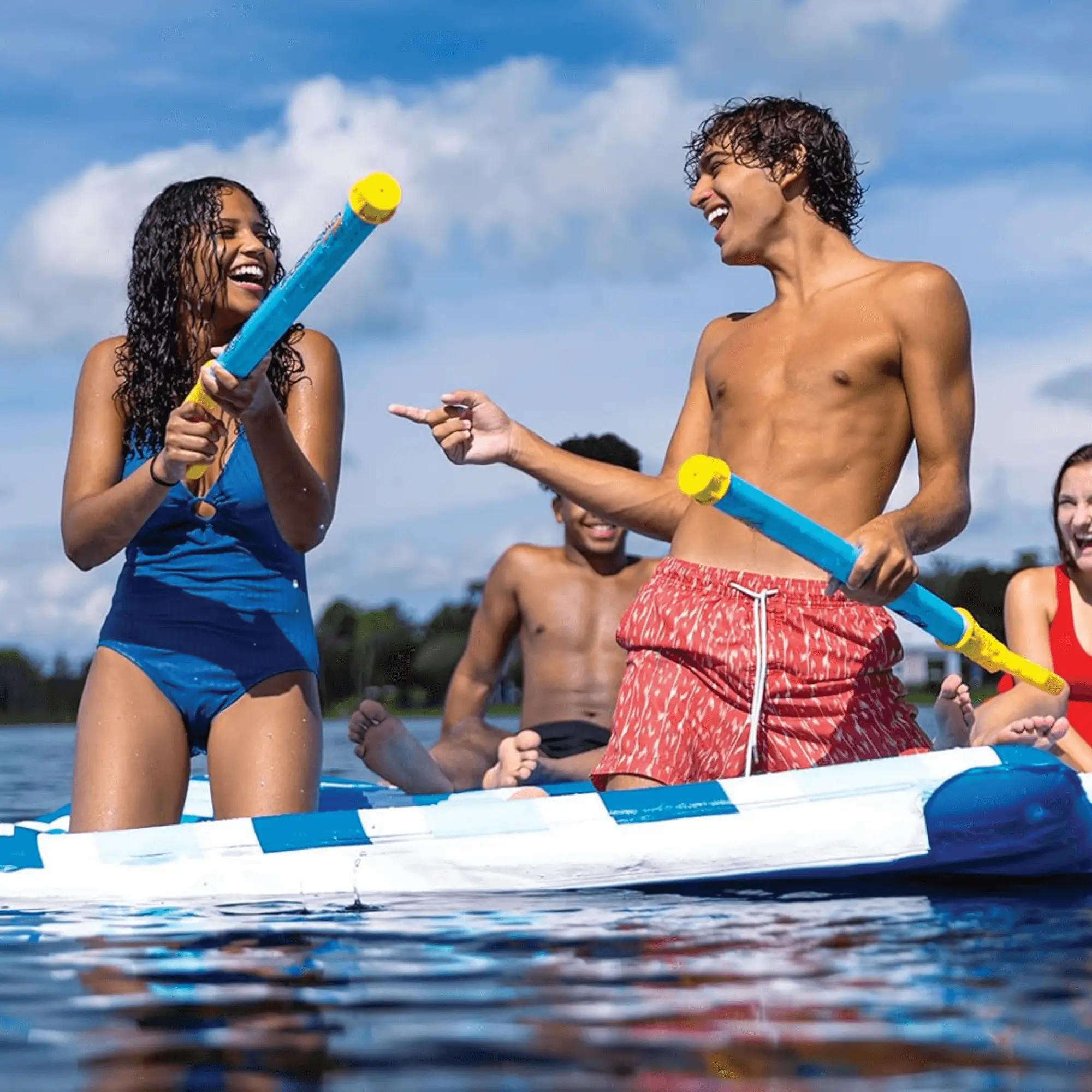 WOW Watersports Splash Cannon water cannons; blue cannons with yellow tips held by two people on a boat