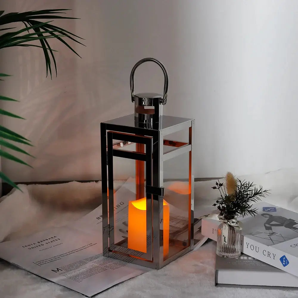 12-inch high silver metal decorative candle lantern with glass panels and a top handle.