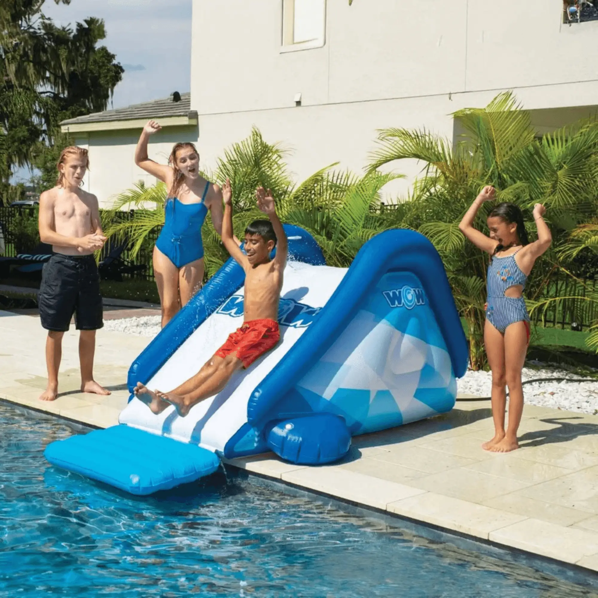 WOW Watersports Cascade Pool Slide, blue inflatable pool slide with kids playing.