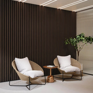 Solid wood acoustic slat wall panels, broad strip, dark brown finish; interior lounge with 2 wicker chairs