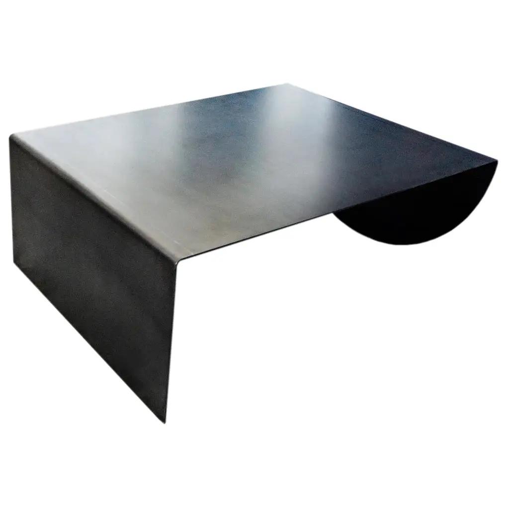 Asymmetrical raw-steel coffee table with a modern industrial look and a curved semicircular cutout.