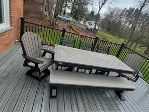 Trestle X Outdoor Bench set on a graywashed wood deck; square-top table with a bench and two chairs.