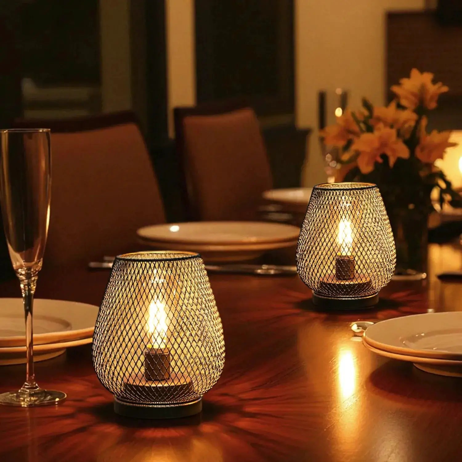 Set of 2 metal cage LED battery-powered table lamps with warm glow on dining table