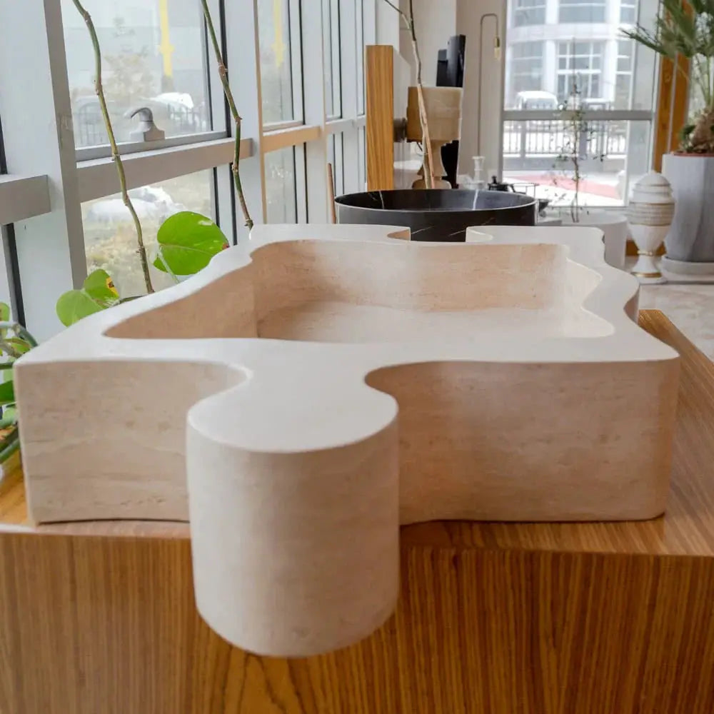 Natural stone beige travertine puzzle-shape bathroom sink above vanity by Villohome